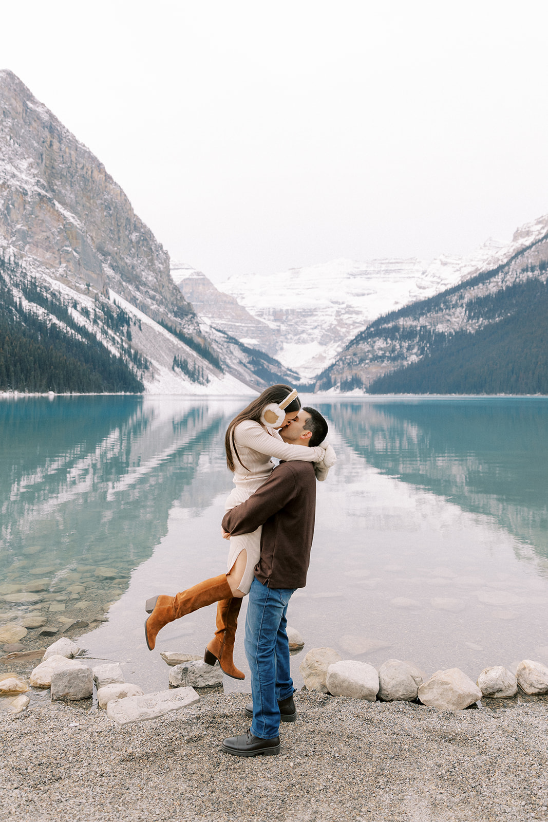 Romantic fall engagement photo of Talissa and Tyler surrounded by fresh snow at Lake Louise.